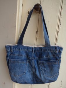 The Jeans Recycling Challenge back view of bag hanging on door