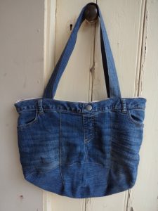 The Jeans Recycling Challenge front view of bag hanging on door