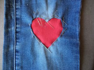 Visible mending heart patch pin edges