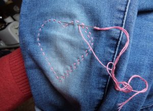 Visible mending heart stitching in pink