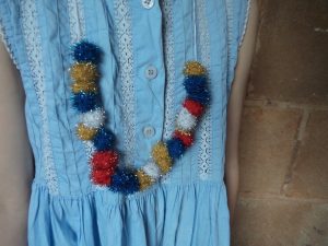 making-festive-necklaces-glitter-pompoms-close-up