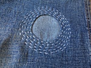 Visible mending circle patch stitched