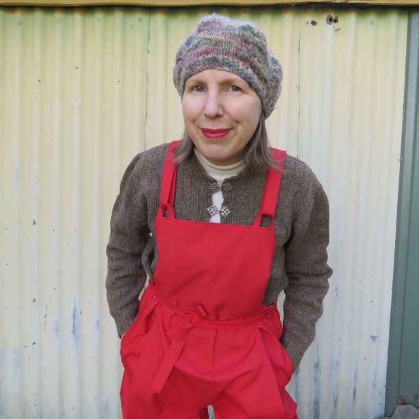 Overalls worn with woollen jumper and knitted beret