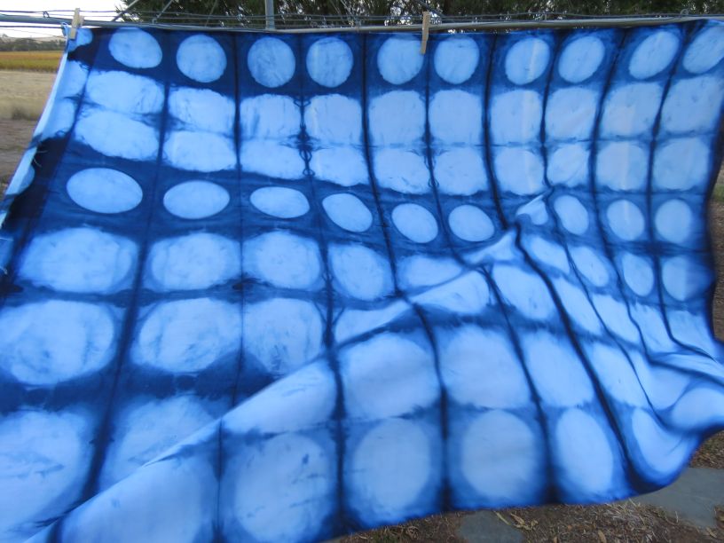 Piece of indigo dyed fabric with circles.